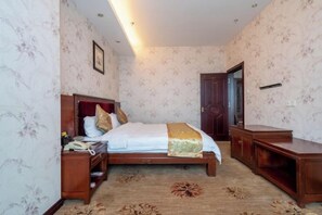 A bedroom with a bed, bedside table, and a wardrobe.