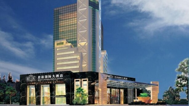 A modern hotel with a tall, rectangular building and a shorter annex. - Beiliu International Hotel (Beiliu)