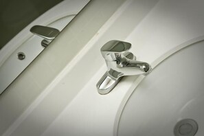 A bathroom sink with a chrome faucet and a mirror above it. - 7 Days Holiday Hotel (Guiyang Gaicha Avenue Zhongshan Middle Road) (Guiyang)