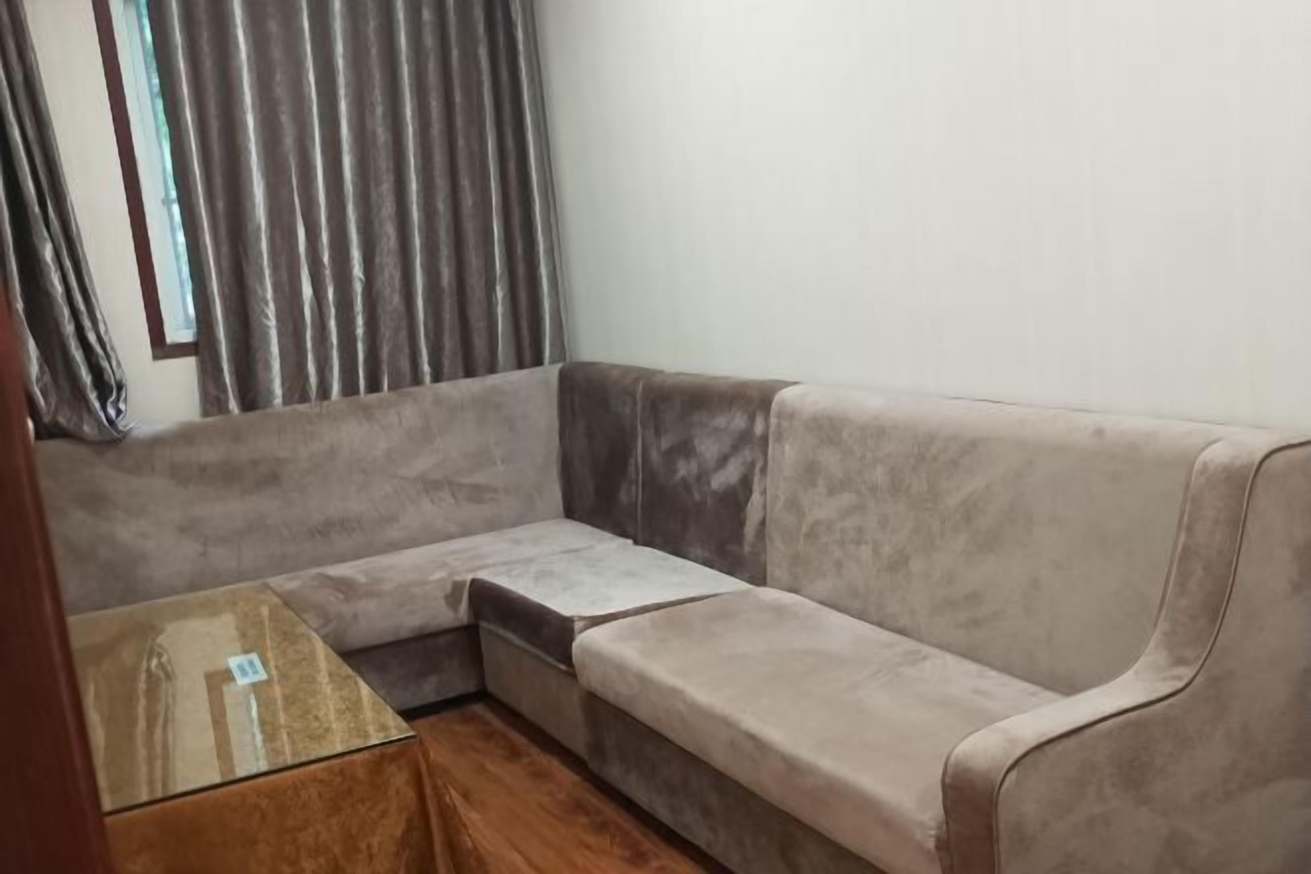 A corner sofa with a wooden table in front.