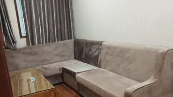 A corner sofa with a wooden table in front.