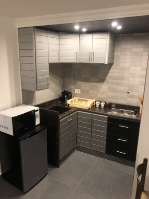 Fridge, microwave, electric kettle, cookware/dishes/utensils