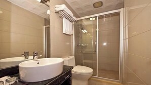 A modern bathroom with a large white sink, a toilet, and a glass-enclosed shower. - Lijing Hostel (Fuzhou)