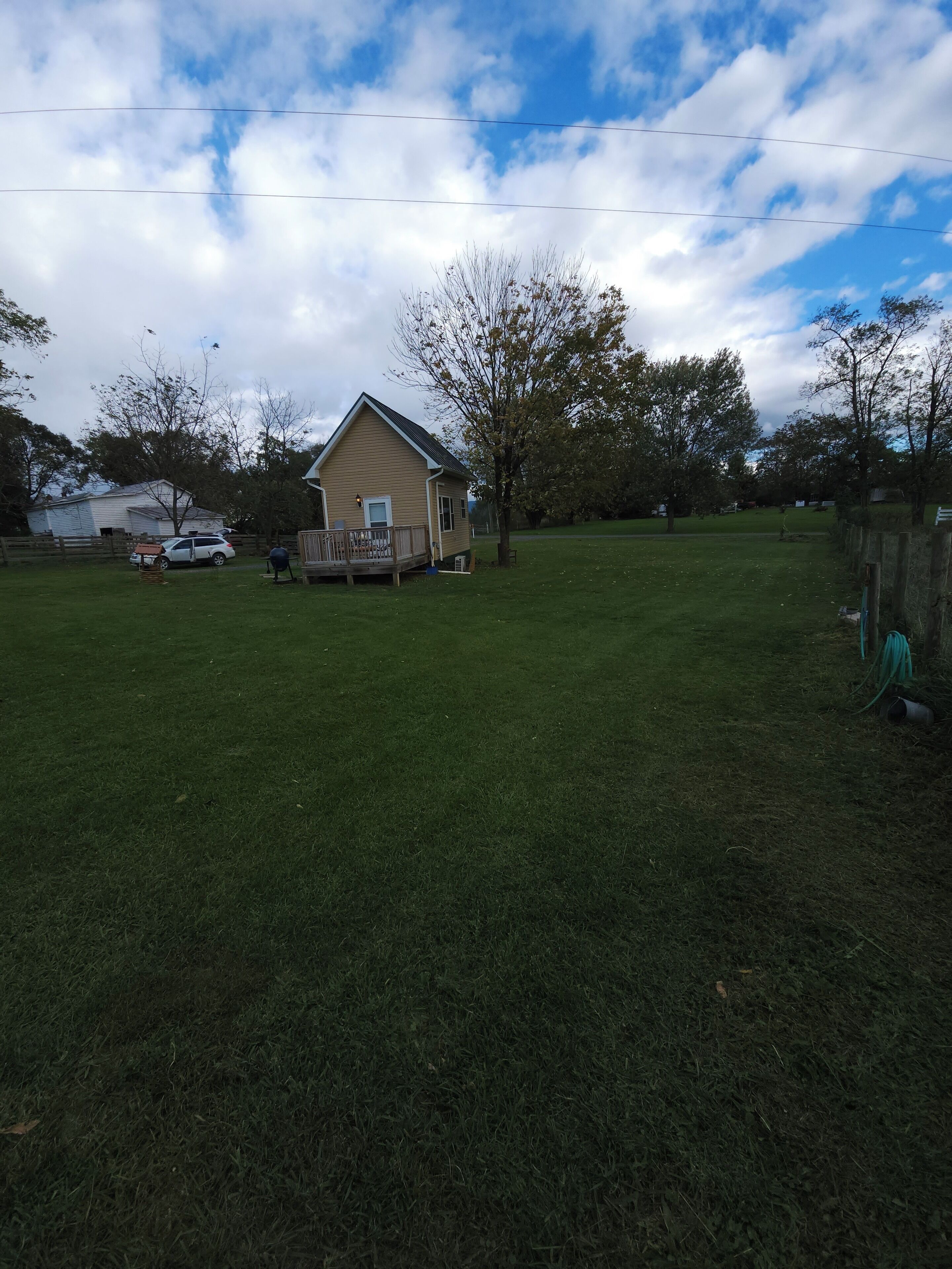 A house with a porch and a fenced yard.