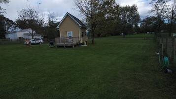 A house with a porch and a fenced yard.