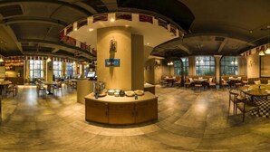 A spacious hotel lobby with a central island, seating areas, and large windows. - Shuang Yi Hotel (Huizhou)