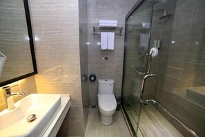 A bathroom with a sink, toilet, and glass-enclosed shower. - Jasmine Bloom Inn (Yidu Chenghe Road) (Yidu)