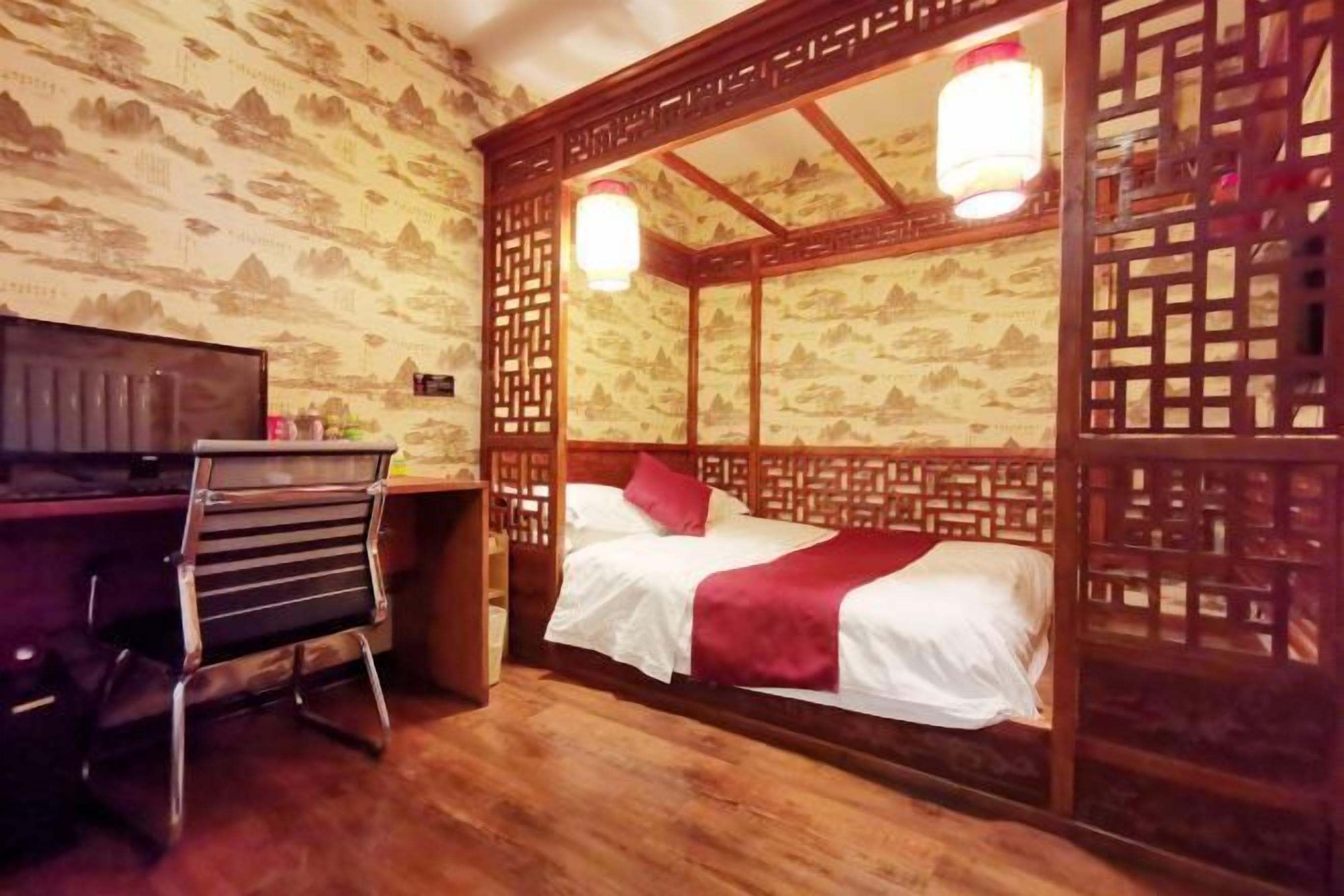 A room with a bed, a desk, and a chair.