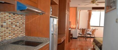 A kitchen with a tiled backsplash, wooden cabinets, and a built-in stove.