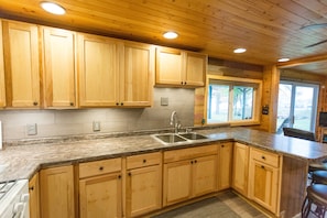 Fridge, microwave, oven, stovetop - Lakefront Family Cabin with Pontoon Rental Available (Hayward)