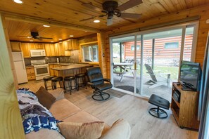 A modern log cabin interior with a kitchen, dining area, and living room. - Hayward Nelson Lake Cabin with Dock, Kayaks, and Pontoon Rental Available Onsite (Hayward)