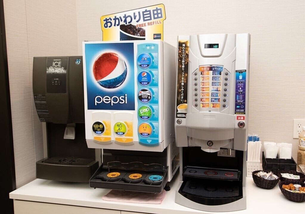 A beverage vending machine with a Pepsi logo and multiple drink options, including ice and zero sugar.