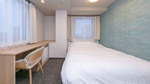 A hotel room with a bed, a desk, and a chair. - Remington Hotel (Akashi)