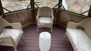 A covered outdoor seating area with wicker furniture and a white ottoman. - Relaxing Rustic ranch at Locust Lake!  with beautiful views!  Close to the Lake! (Pocono Lake)