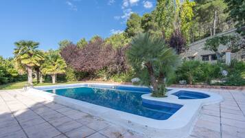 Una piscina al aire libre, tumbonas