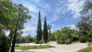 A paved pathway in a park with tall trees and a clear sky. - Heyden 3 · Top Floor Renv 3BDR APT / “Pedion tou (Athens)