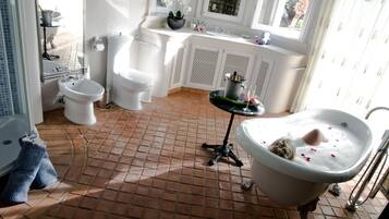 Bathroom features a pedestal sink, bathtub, and toilet with a porcelain finish.