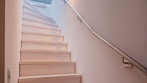 A staircase with a skylight above, leading to an upper floor. - Sky suite with unobstructed sea view, roof terrace and balcony (Ostseebad Binz)