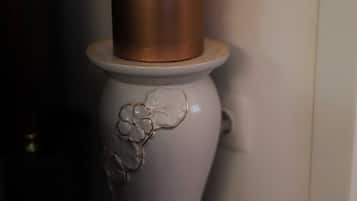 A white pedestal with a candle on top.