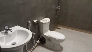 A bathroom with a white sink, toilet, and shower. - The most comfort rest starts here (Habaraduwa)