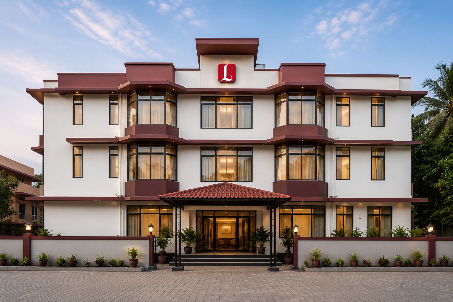 Ein mehrstöckiges Hotel mit markanter Rot-Weiß-Farbgebung, das einen großen Eingangsbereich mit einem geflasten Dach und Pflanzkübeln zeigt.
