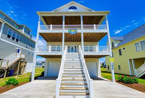 Un immeuble à plusieurs étages doté d’un escalier central, d’une enseigne indiquant « Shoreline Suites » et offrant une vue sur le quartier environnant.