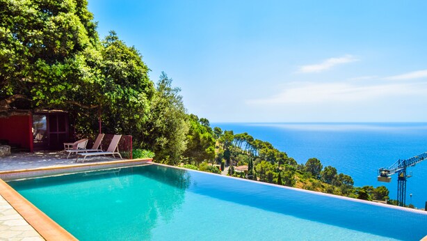 A rectangular swimming pool with clear blue water, surrounded by a tiled deck. - Spectacular Villa with sea views.Begur. (Begur)