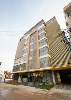 A modern hotel with a prominent entrance, multiple floors, and a decorative facade. - Clarks Inn, Airport Bangalore (Bengaluru)