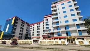 A multi-story hotel with a modern design, featuring balconies on each floor and a central entrance with a decorative facade. - Hotel Sea World Cox's Bazar (Cox's Bazar)
