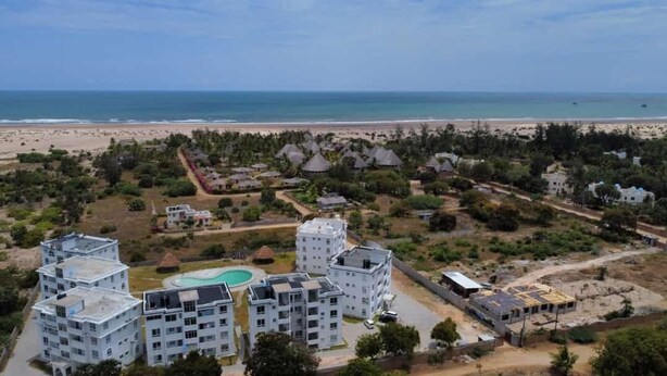 An aerial view of a resort with multiple buildings, a swimming pool, and a beach in the background. - Inviting 1-bed Apartment in Malindi (Malindi)