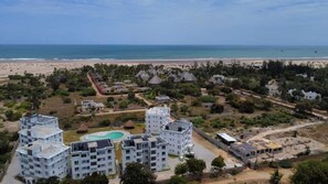 An aerial view of a resort with multiple buildings, a swimming pool, and a beach in the background. - Inviting 1-bed Apartment in Malindi (Malindi)