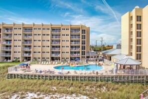 Enjoy stunning beach views from your balcony, relax by the pool surrounded by lounge chairs and umbrellas.