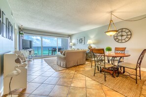 Relax in this inviting living area with a sofa set, dining table, and flat-screen TV.