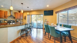 A spacious kitchen with wooden cabinets, a built-in stove, and pendant lighting. - Idyllic Somerset Condo: Ski, Hike & Relax! (Somerset)