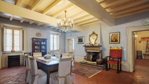 A dining area with a wooden table, chairs, and a chandelier. - Villa / Independent home in Lucca with 9 bedrooms sleeps 18 (Lucca)