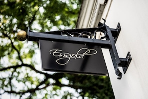 Welcome to Essgold, a charming building nestled in a lush green setting.