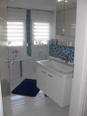 Bathtub, hair dryer, towels, soap