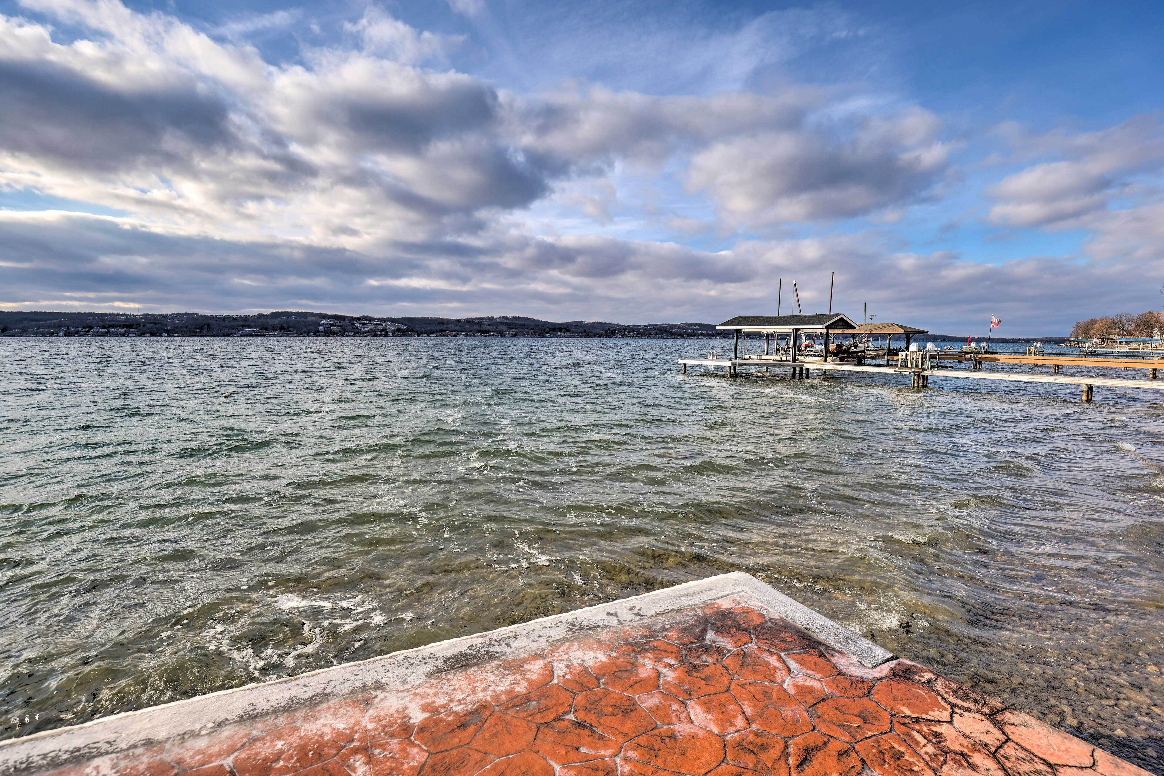A waterfront dock with a covered seating area and a flag.