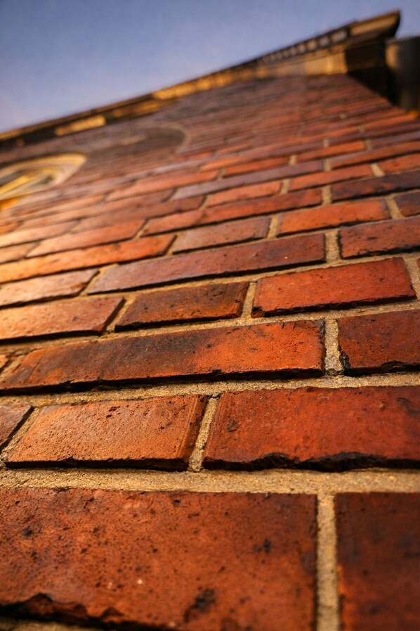 A close-up of a red brick roof with visible mortar joints.