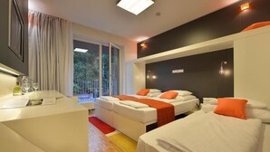 A modern hotel room with two beds, a sitting area, and a reception desk. - Omnia Hotel Relax & Wellness (Janske Lazne)