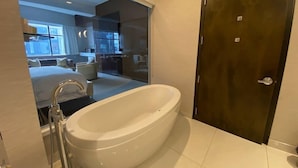 A modern bathroom with a freestanding bathtub, a shower, and a toilet. - Room in luxurious downtown property (St. John's)