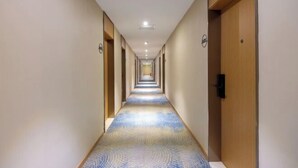 A long, narrow hotel corridor with doors on both sides and a patterned carpet. - Starway Hotel (Beijing Yanqi Development Zone) (Beijing)