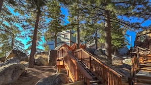 A wooden staircase leading up to a building surrounded by large rocks and pine trees. - Scenic Escape - Best Views of Lake Tahoe! (Stateline)