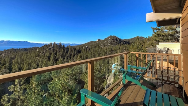 A wooden deck with a view of a forest and mountains. - Scenic Escape - Best Views of Lake Tahoe! (Stateline)