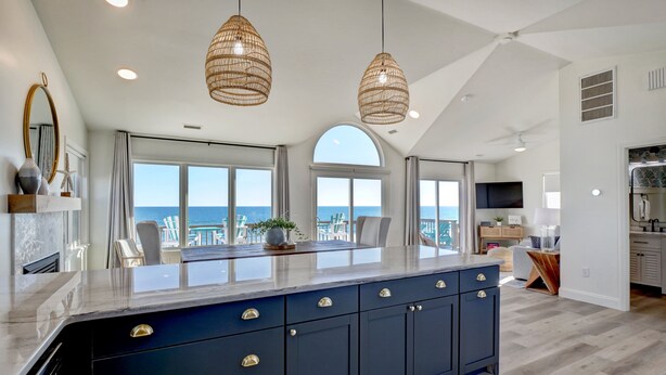 A spacious kitchen with a large island, pendant lighting, and a view of the ocean. - Remodeled Oceanfront w/ Hot Tub, 2 Decks, Walk to Surf City Pier, Pet-Friendly (Surf City)