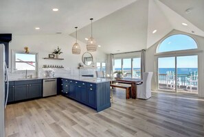 Enjoy ocean views from the kitchen window, where a central island offers a sink and dishwasher.
