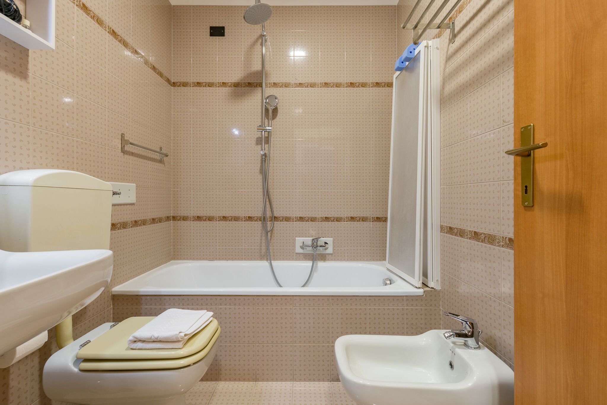 A bathroom with a bathtub, a bidet, and a toilet.