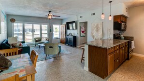 A spacious kitchen with a large island, wooden cabinets, and pendant lighting. - 3 Bed 2 Ba, Wifi, Kitchen, Walk to Beach, FirePit (Daytona Beach)