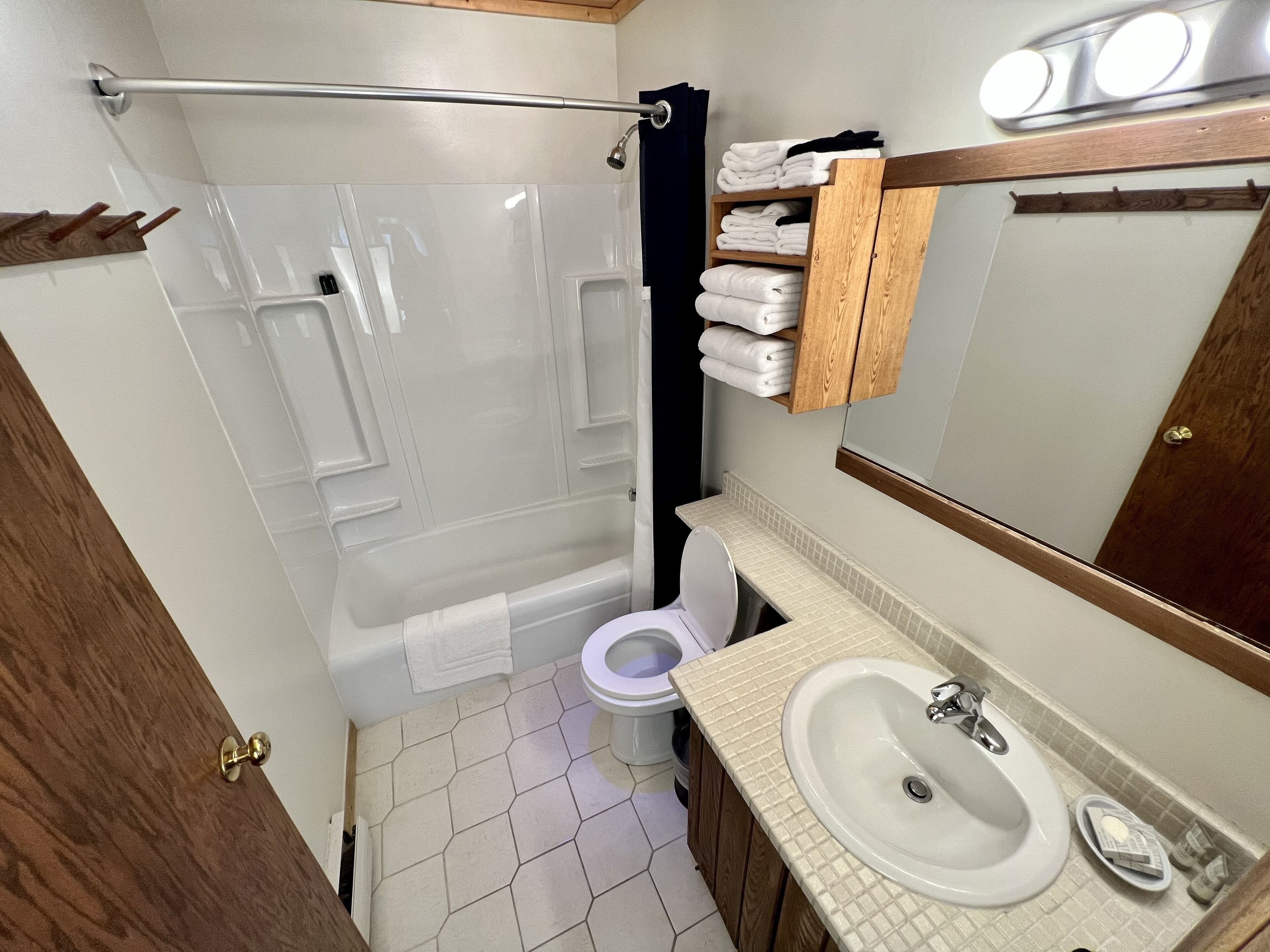 A bathroom with a bathtub, toilet, and sink.
