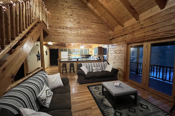 The living room has a wood framed glass swing door which leads to upper deck.